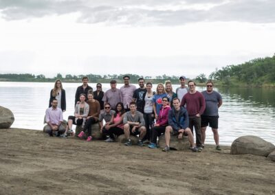 group of people are standing next to river