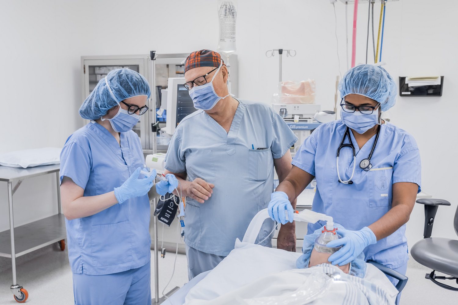 Doctors working on patient in operating room Doctors working on patient in operating room
